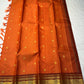 TEJAS – Vibrant Rust Orange Podi Kattam Kanchipuram Silk Saree

Micro-checks body with scattered gold chakram buttas; rich contrast maroon korvai borders

Grand circular annapakshi medallions in lustrous zari; ornate-jaal pallu & tassels

Silk Mark