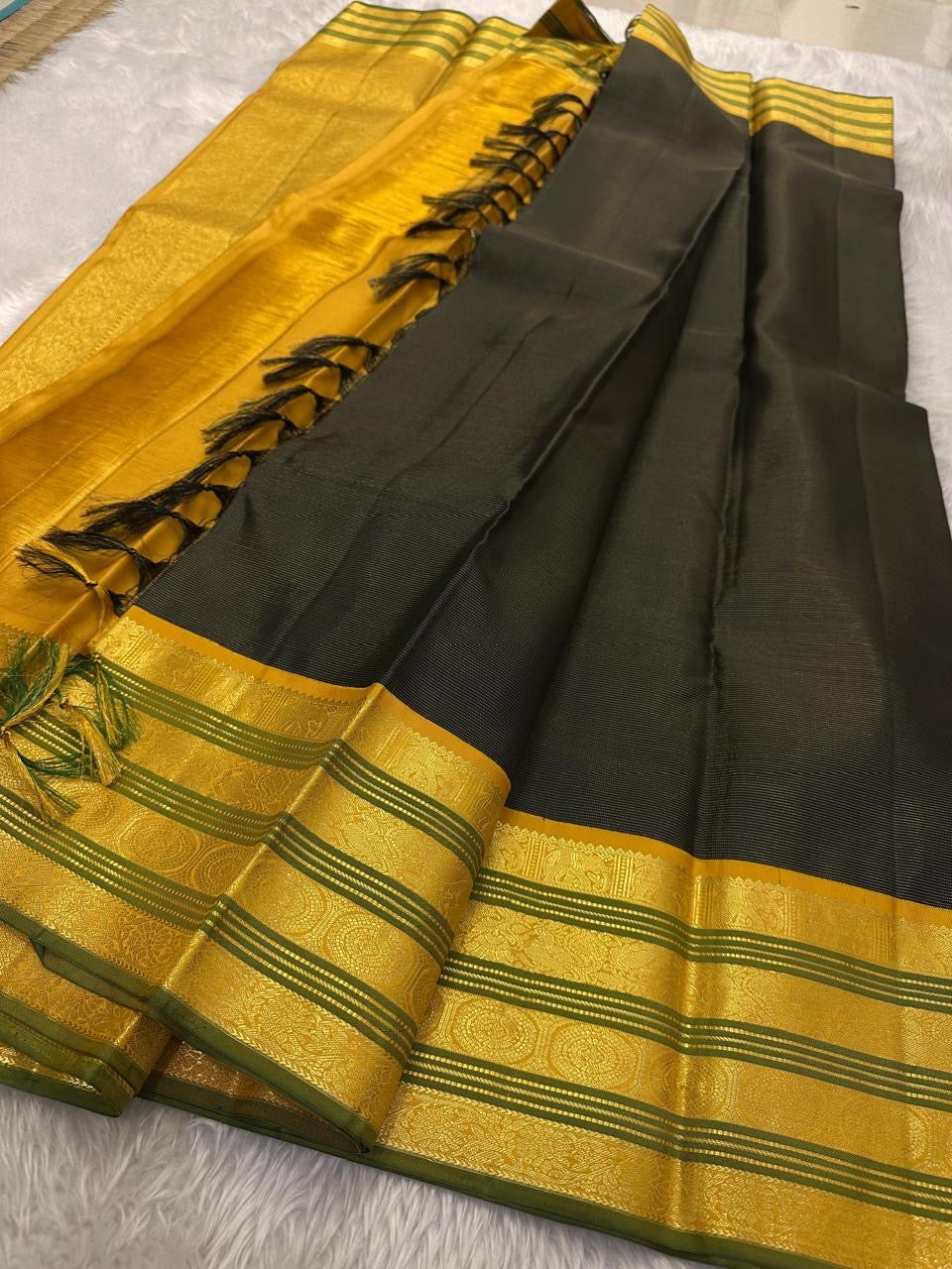 Adar Manjal Chakram – Pure Kanchipuram Silk Saree
Deep green  & Manjal-Gold Zari Korvai Borders 
Chakram & Floral Zari Motifs, Grand Manjal Brocade Pallu
Silk Mark | Fall & Pico Done | Blouse Stitching Available | ships in  2 weeks