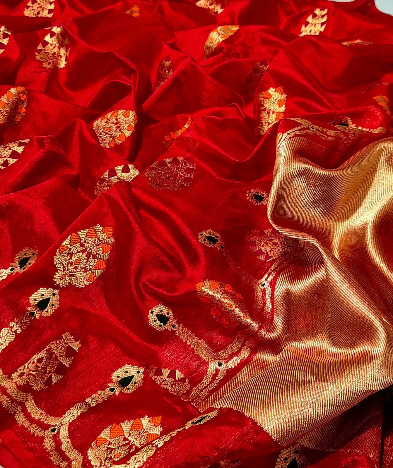 Vermillion red Chanderi silk saree with ornamental multicolour border, gold motifs and metallic pallu