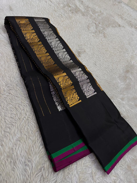 Lavanya – Black Handwoven Kanchipuram Silk Saree with Gold & Silver Zari

A timeless black Kanchipuram silk saree with intricate gold and silver zari motifs — Gandaberunda, parrots, elephants, and lotuses — exuding regal elegance.