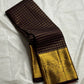 Mathura Layam — Pure Silk Kanchipuram Saree
Deep espresso brown with gold varisaipet checks & peacock zari border
Vermilion red vaira-kattam pallu | Silk Mark Certified | Ships in 2 Weeks | Free USA Shipping