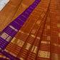Pankajam 🌺 – Burnt Orange Kanchipuram Silk Saree with Zari Kattam, Dashed Lines, Kolam Motifs, Varisaipet Border with Thandavalam Zari Stripes, Rudrakshpet, Annam & Kamalam Motifs, Deep Magenta-Purple Selvedge & Ornate Pallu