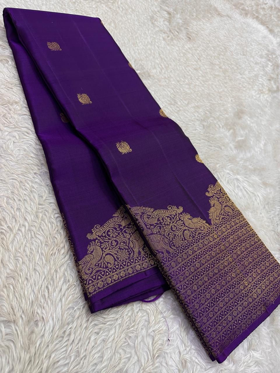Lotus Glow — Violet | Pure Kanchipuram Silk Saree
A royal violet canvas with antique-gold zari peacocks, elephants & lotus motifs ✨
Silk Mark Certified • Free USA Shipping • Ships in Two Weeks