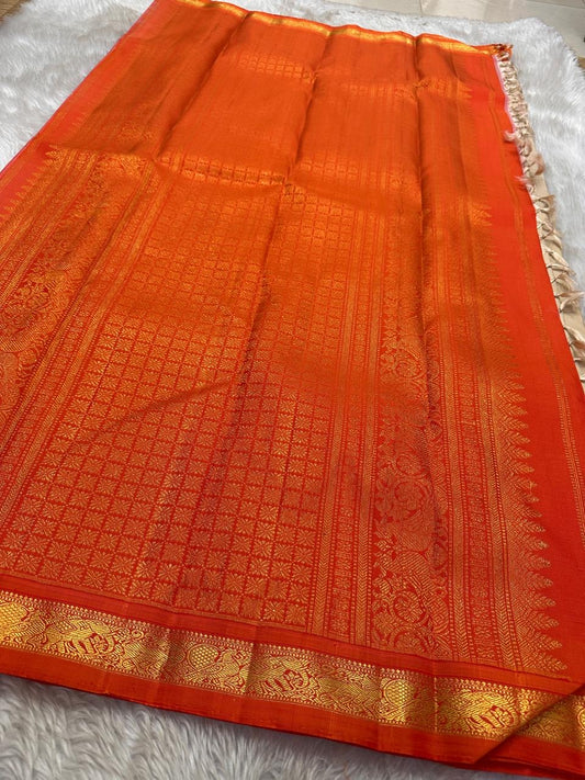 Amber Shubhra Butta — Pure Kanchipuram Silk Saree
Ivory body with golden zari buttas and vibrant amber-orange pallu
Pure 3gm zari • Silk Mark Certified • Free Shipping within USA