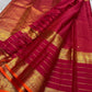 Open view of pink-red Kanchipuram silk saree with tasselled pallu, horizontal gold zari lines and ornate elephant border with orange selvedge.