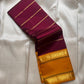 Half-folded deep maroon pure Kanchipuram silk saree with fine gold zari lines and mustard contrast zari border.
