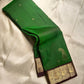 Shringaram – Green — Pure Silk Kanchipuram

Emerald-green body with coin buttas & grand mango (mankolam) motifs

Deep coffee-brown korvai borders with peacock panel zari

Rich coffee-brown brocade pallu with circular & diamond jaal

Silk mark