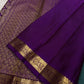 Close view of purple pallu with dense gold zari woven geometric pattern and a gold floral border.