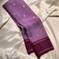 Ilam  Vadamalli Chakram — Kanchipuram Pure Silk

Pastel lilac–mauve body with gold & silver chakram buttas

Deep plum contrast border with twin kaddi zari lines

Plum pallu with elegant vertical zari stripes; lilac tassels

Silk Mark Certified •