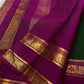 Magenta pallu close-up with intricate gold zari border featuring woven animal and floral motifs