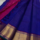 Sapphire Zari Kattam – Pure Kanchipuram Silk Saree
Brilliant Sapphire Blue Body with Gold Zari Checks
Broad Golden Border with Magenta Highlights & Temple Motifs
Royal Magenta Pallu with Lustrous Zari Stripes

Silk Mark Certified, delivery in 2 weeks