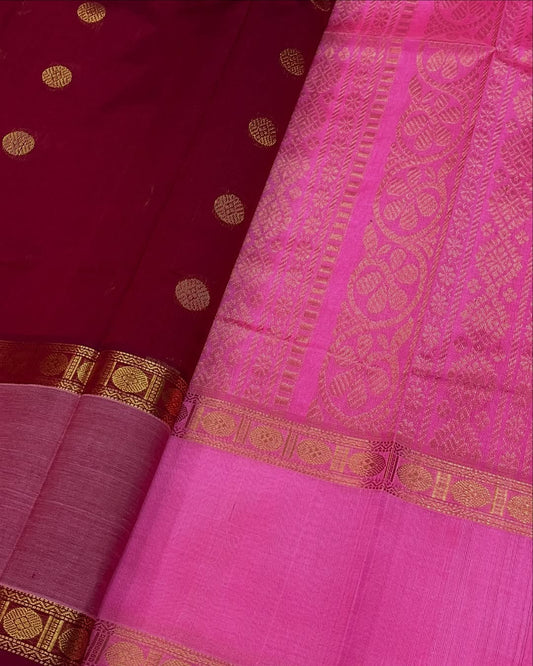 Cherry Red Silk Cotton Saree  
Raspberry Pink Rettapet Border  
Pavun Coin Butta All Over  
Grand Floral & Rudraksham Pallu