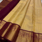 Ragini – Ivory & Gold Kanchipuram Pure Silk Saree with Floral Jaal & Maroon Baavanji Border
Timeless elegance shines through the delicate ivory base and shimmering gold zari floral jaal. The rich maroon Baavanji border and intricate pallu details complete