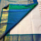 Mayilkazhuthu Shwetham — Pure Kanchipuram Silk Saree
Soft Ivory-Blush Body with Gold Zari Buttas & Peacock Blue-Green Border
Silk Mark Certified • Free Shipping within USA • Ships in Two Weeks