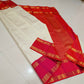 Ivory & Vermilion Rettapet Kattam
Pure Kanchipuram Handloom Silk
Auspicious Red Glow with Gold Zari Grid