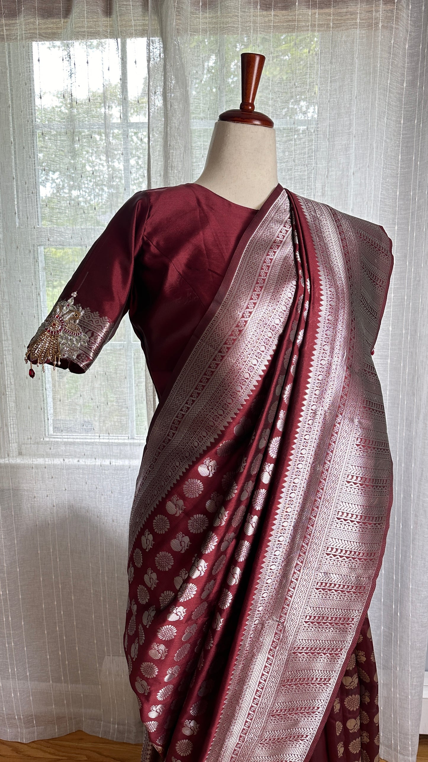 Maroon silver and gold Saree with peacock motif embroidery embellished with temple jewelry style stone work