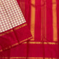 Close view of deep red pallu with vertical gold zari woven stripes and a matching border, next to the checked cream panel.