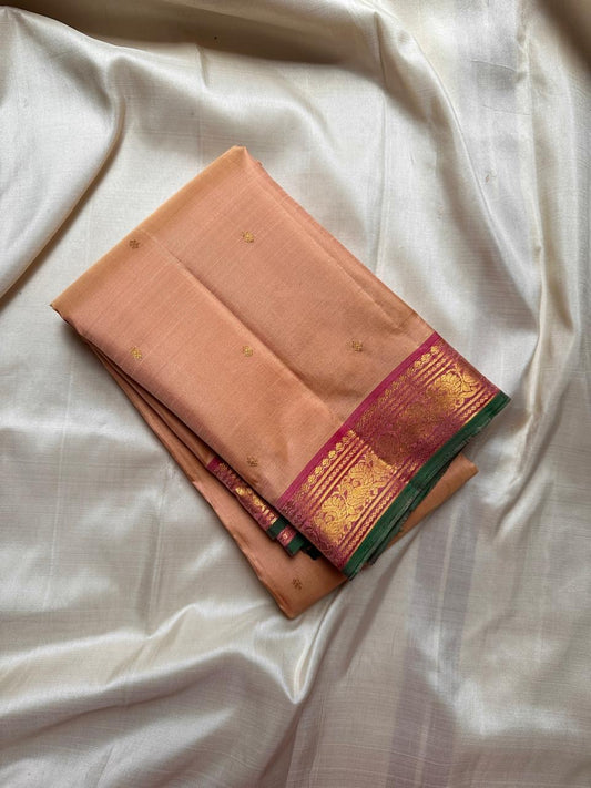 Pure silk kanchipuram Biscuit beige  color body with zari buttas , magenta mayil border with green selvedge
