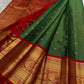 Decorative peacock-style border panel woven in gold zari on the red border.