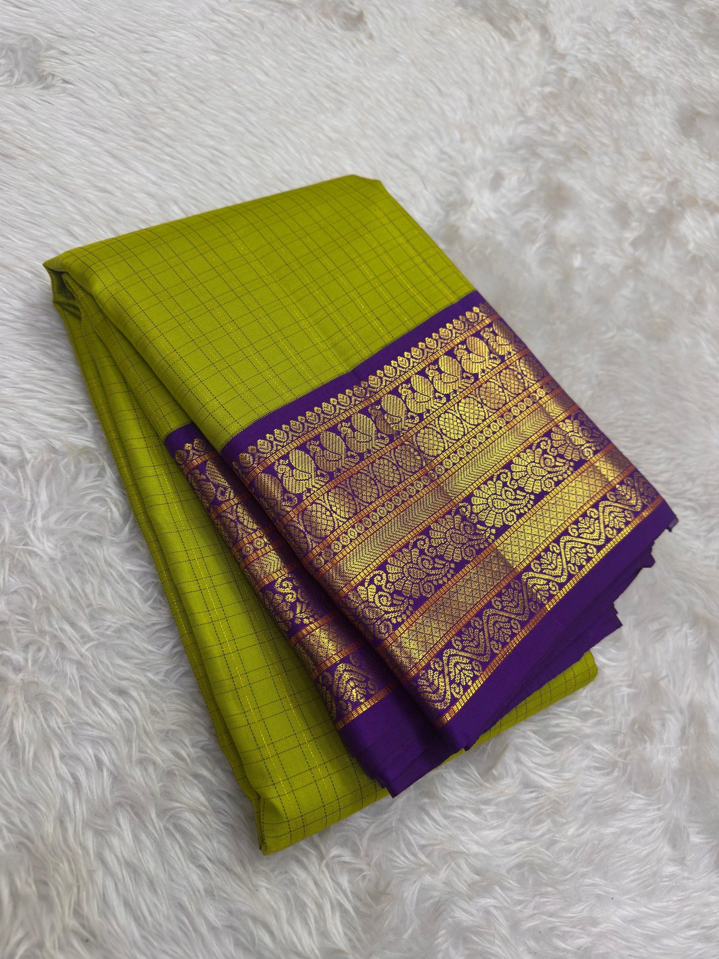 Chartreuse green Pure Silk Kanjivaram saree with rich indigo border and heritage Annapakshi weaving