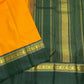 Folded saffron gold and deep green Pure Silk Kanchipuram Korvai saree showing contrast border