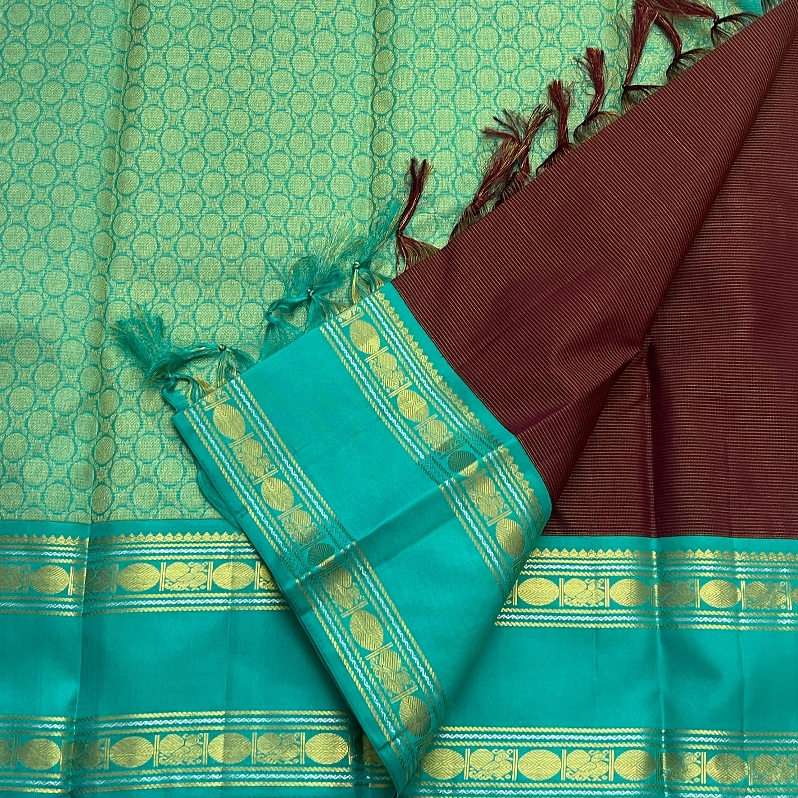 Fresh teal border with traditional gold zari motifs on pure Kanchipuram silk saree