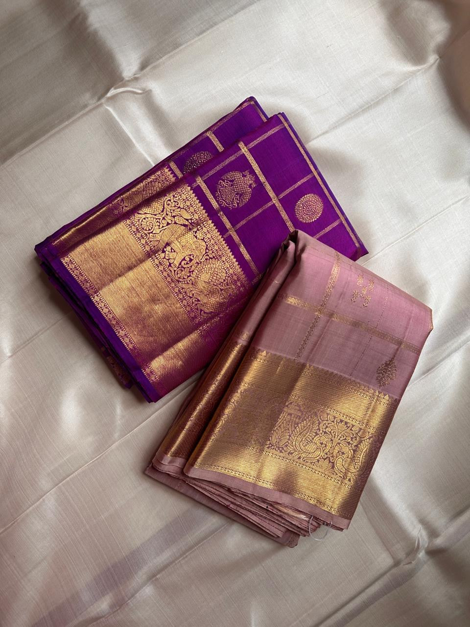 Amethyst Gandaberunda Kamalam – Pure Kanchipuram Silk Saree

Amethyst Purple Body with Zari Kattam Checks & Lotus Buttas

Grand Antique-Gold Borders with Gandaberunda & Peacock Motifs

Purple Zari Brocade Pallu

Silk Mark , ships in 2 weeks
