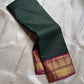 Pachai Zari Kattam – Pure Kanchipuram Silk Saree
Deep Emerald Green Body with Gold Zari Checks
Broad Golden Border with Magenta Highlights & Temple Motifs
Royal Magenta Pallu with Lustrous Zari Stripes

Silk Mark Certified, delivery in 2 weeks