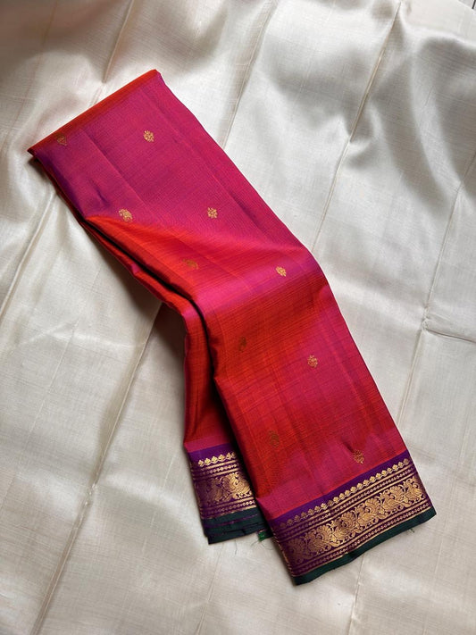 Pure silk shot rust  and red with purple mayil border with green selvedge flower ane paisley butta