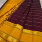 Open drape view of pure Kanchipuram silk saree showing maroon body with mustard zari border and tasselled pallu edge.