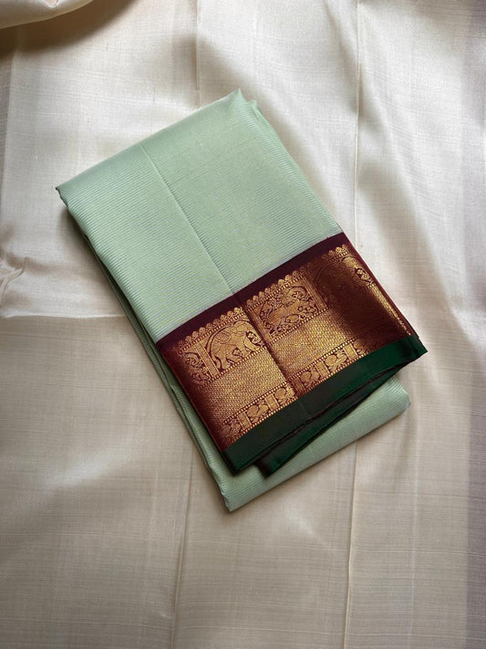 Pistachio Mist ✨ – Pastel Pistachio Vairaoosi Kanchipuram Pure Silk Saree
Korvai Wine-Maroon Border with Elephant Procession Zari Panel & Green Selvedge
Grand Gold Zari Pallu with Chevron & Silk Mark Certified | Fall & Pico Done | Blouse Stitching ($30) |