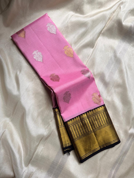 Roja Sonaroopa – Pure Kanchipuram Silk Saree
Blush Pink Body with Gold & Silver Paisley Buttas
Ebony Korvai Border with Temple Pillar Zari Design
Antique Gold Brocade Pallu with Grand Detailing

Silk Mark Certified, delivery in 2 weeks