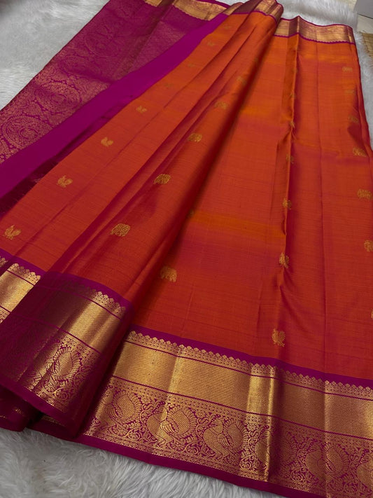 Sunset Symphony lux cascade of silk in vibrant orange and pink shot double shade pure silk Kanchipuram with peacock bavanji border and elephant and peacock butta