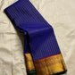 Neela Ratnam — Pure Silk Kanchipuram

• Cobalt-blue kattam checks with antique-gold zari

• Ruby-maroon contrast pallu with grand zari work

• Floral vine borders with bottle-green selvedge

• Silk Mark Certified • Ships in Two Weeks • Free Shipping withi