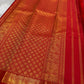 Mahima –red
A luminous red pure silk Kanchipuram drape adorned with delicate baby  kamalam buttas. The petite border features muthu seer and zari-woven elephants with floral vines. Its grand pallu showcases annams, golden grids, and Rudhraksham seer.