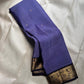 Classic heritage finesse in this lilac blue pure Kanchipuram silk saree Zari kattam , intricately handwoven with fine golden checks across the body. Scattered floral buttas add delicate charm,rich purple peacock border
