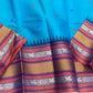 Peacock-teal body with woven silk-thread buttas in navy & coral hues
Korvai contrast ruby-maroon borders with gaja-chakram & temple motifs
Grand varisaipettu striped pallu in navy, mustard & maroon tones
Silk Mark Certified • Ships in Two Weeks