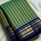 Mayil Pachai Kattam
Pure Kanchipuram Silk Saree + blouse Peacock Green & Mustard pattani Checks
Royal blue korvai borders with 2g floral zari detailing
Fully stitched embroidered blouse
Ships in 2 weeks free silk mark certified