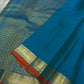Peacock Teal Ilai Butta – serene teal body with copper-gold zari borders

Pure Kanchipuram silk • dainty leaf (ilai) buttas scattered across the body
Rich teal zari pallu

Silk Mark Certified | Fall & Pico Done | Blouse Stitching Available ($30)