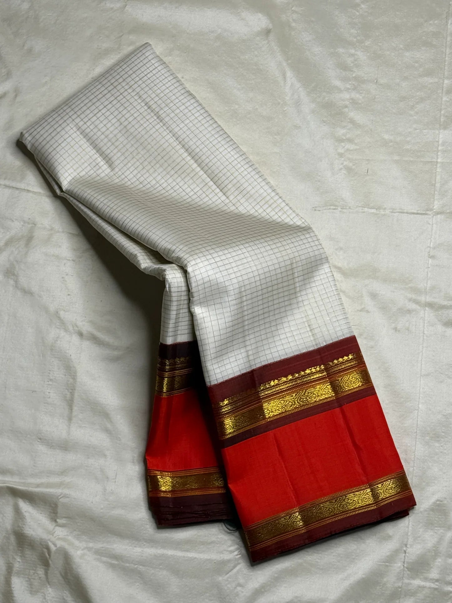 Shveta Arakku Kattam
Pure Silk Kanchipuram Saree – White Body with Fine Kattam Checks
Contrast Arakku Red Border & Maroon Korvai with Rich Zari Weave
Grand Zari Pallu Featuring Intricate Traditional Motifs
Silk Mark Certified ✅ Fall & Pico Done