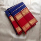 Meera – A Living Raga in Kanchipuram Silk: Draped in Crimson and Iconic MS Blue, Adorned with Gold Zari Seer, Muthu Borders, and Peacocks and kamalam , Woven in the Spirit of Classical Grace and Devotion