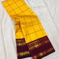 Marigold Yellow & Arakku Pure Silk Kanchipuram Saree
Classic kattam checks across the radiant marigold body
Deep arakku-maroon korvai borders with coin medallion zari
Rich maroon pallu with traditional zari  motifs
Silk Mark Cert • Ships in 2 weeks