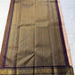 Sandhya 🌅 – Sun-Kissed Beige Kanchipuram Silk Saree with Subtle Vairaoosi Gold Filament ✨, Deep Purple Peacock Diamond-Pettu Zari Border 🦚, Deep Maroon Selvedge, and Zari-Embellished Pallu with Arai Maadam & Khalasam Motifs 🌿💛