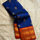 Royal blue Kanchipuram silk saree folded with coin buttas and red zari woven border