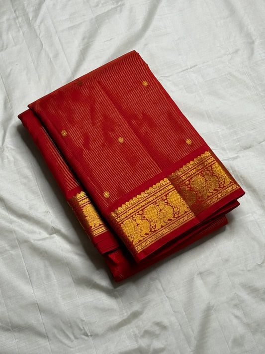 Vermillion Swarna Vairaoosi — Pure Kanchipuram Silk Saree
Vermillion red body with fine vairaoosi stripes, gold rosette buttas, and Gandaberunda borders in antique zari.
Silk Mark Certified • Free Shipping within USA • 2 weeks