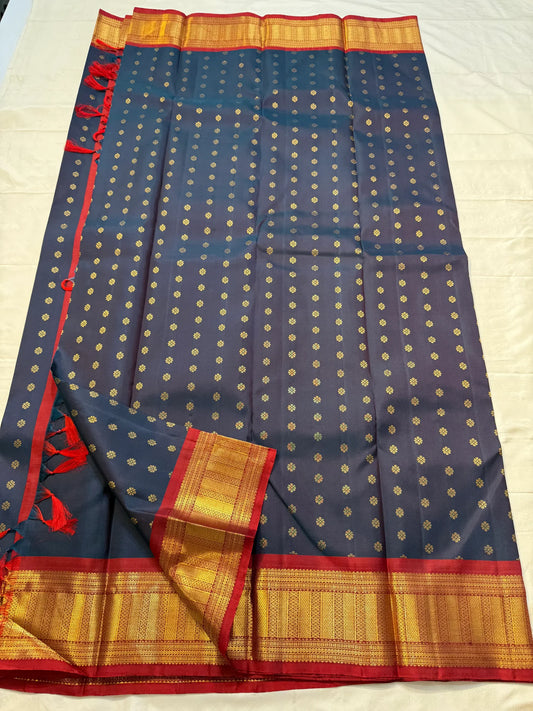 Midnight Neelam Flower Butta — Kanchipuram Pure Silk


Deep midnight neelam (navy) body with scattered gold flower buttas

Korvai contrast maroon borders with grand + geometric zAri motifs 

Rich zari pallū with ornamental motifs; hand-twisted tassels
