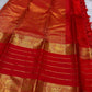 Full layout of red Kanchipuram silk saree with grand woven zari pallu, elephant borders and gold horizontal stripes.
