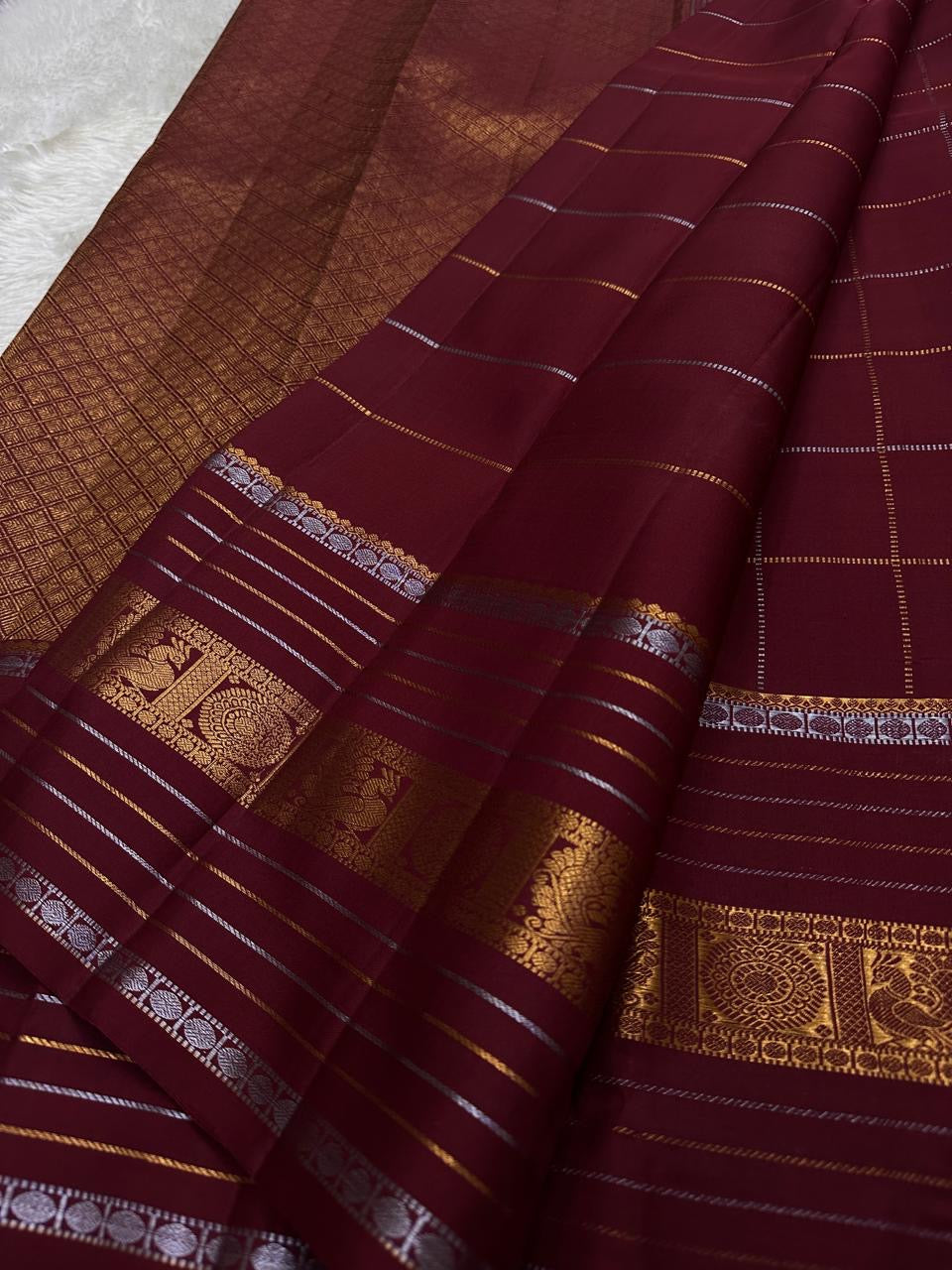 Pankajam 🌺 – Brown maroon Kanchipuram Silk Saree with Zari Kattam, Dashed Lines, Kolam Motifs, Varisaipet Border with Thandavalam Zari Stripes, Rudrakshpet, Annam & Kamalam Motifs, Deep Brown Selvedge & Ornate Pallu