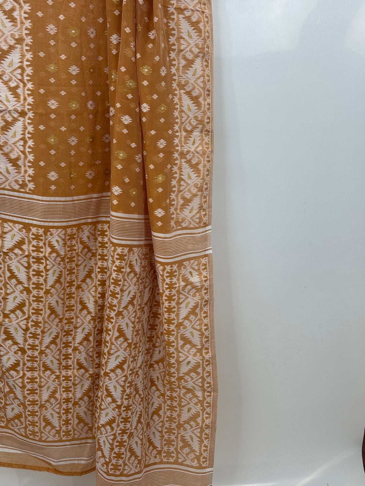 Full drape of biscuit-brown Jamdani saree with intricate ivory border detailing