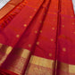 Agnika – Tomato orange shot Red Kanchipuram Silk Saree with Mayil Chakram Butta & Orange Border
Fiery and regal, Agnika is a pure Kanchipuram silk saree featuring a rich red body adorned with intricate Mayil Chakram buttas.